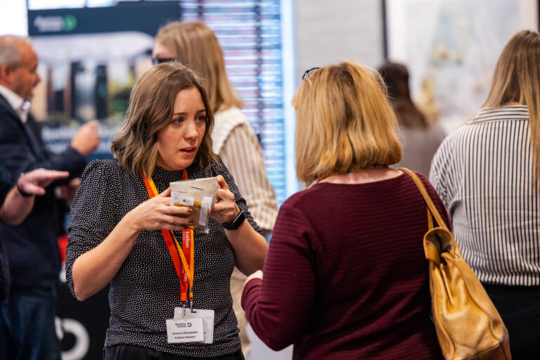 Two female adults in discussion at a networking event in Durham