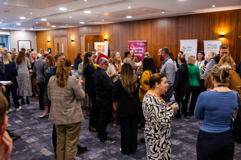 A group of adults attending a networking event in Durham